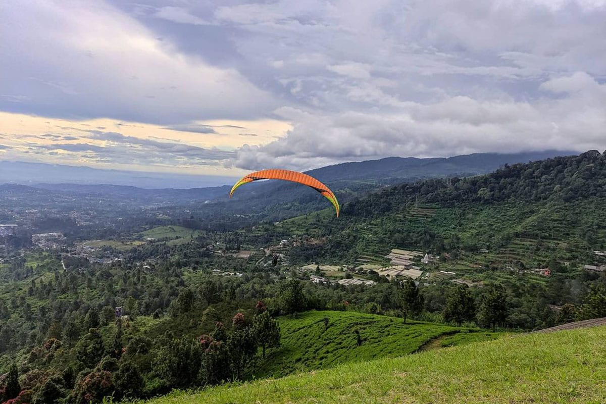 a guy paragliding above Tugu Selatan Village Bogor West Java